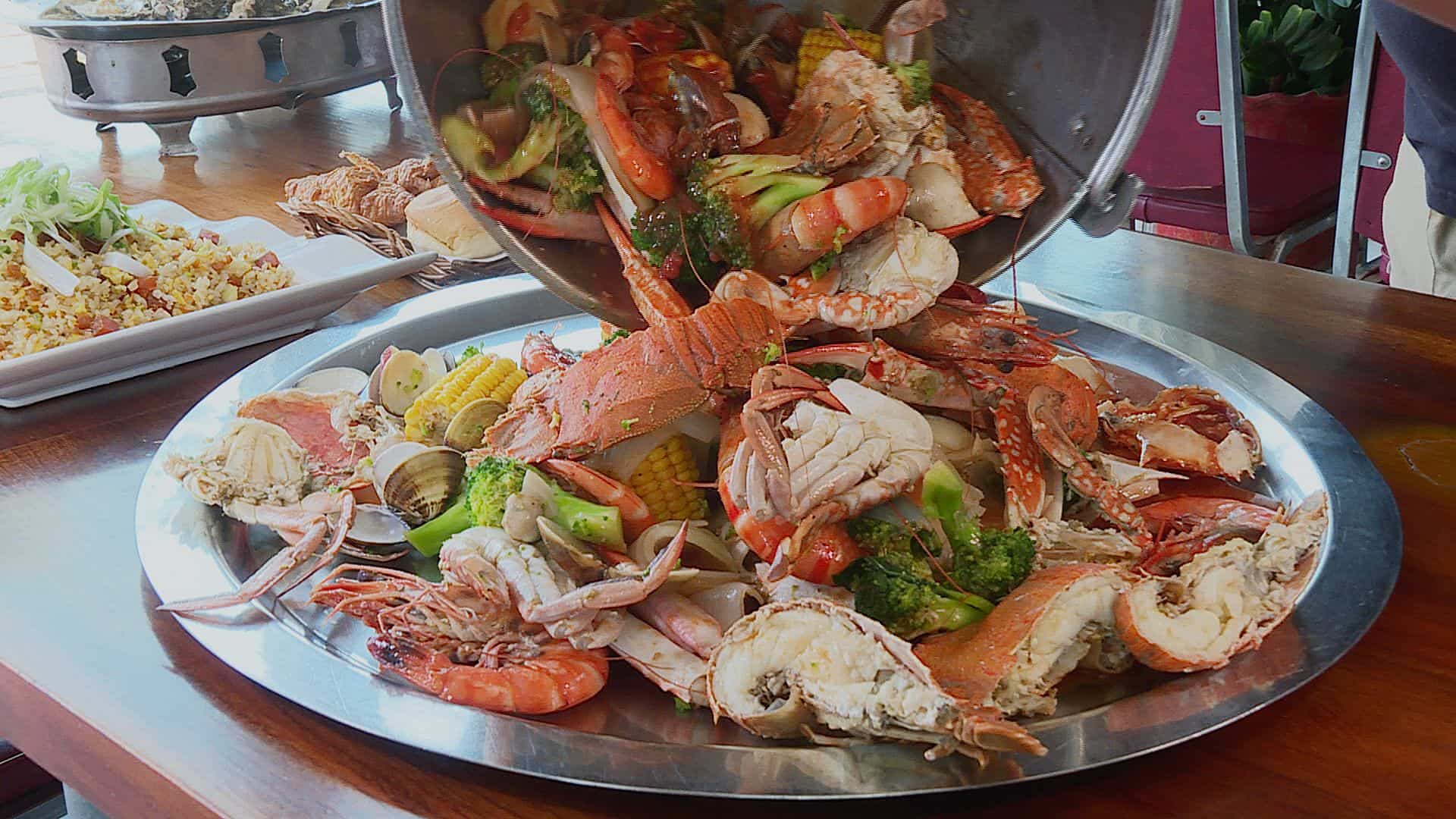 螃蟹、大蝦、蛤蜊、九孔鮑等等新鮮海產從水桶內霸氣倒入桌上鐵盤，應有盡有，視覺效果超震撼。（記者許惟凱／攝影）